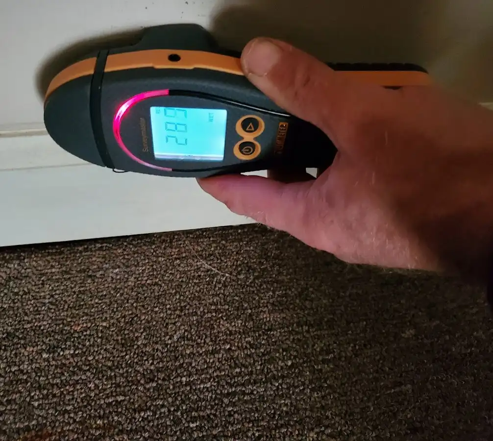 Moisture detection at baseboard during Storm Damage Restoration in Fort Washington